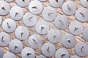 Lot of pushpin top view on wooden surface macro background