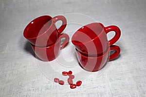 Lot of red colored ceramic coffee cups