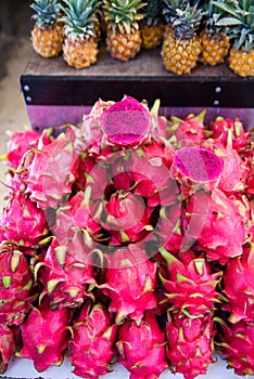 A lot of red ripe pitaya or white pitahaya dragon fruit on outdoor market.