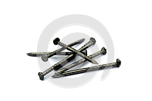 A pile of iron nails lie on a white background