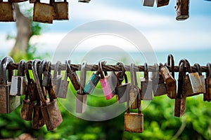 Lot of rust lock hang on metal balcony with blue sky and tree ba