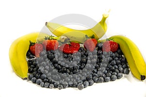 Lot`s of blueberry`s and red strawberry`s with three yellow and green banana`s