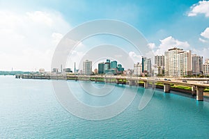 Lot`s of cars passing highway road along Han river with business and residential area near by - Seoul, South Korea