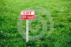 Lot for sale plate sign, green grass background