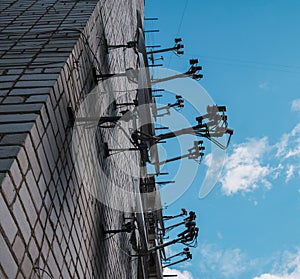 A lot of satellite dish antennas on the roof. Blue sky background