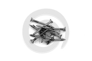 A lot of self-tapping screws lie on a white isolated background