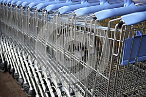 A lot of shopping trolleys. Blue modern supermarket shopping carts in a row