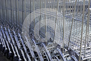 A lot of shopping trolleys. Modern supermarket shopping carts in a row