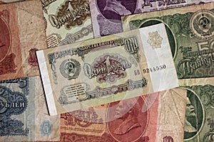 A lot of Soviet paper money, USSR banknotes of different denominations. Old and inactive money. Background