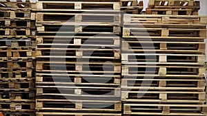 A lot stacks of used wooden pallets of euro type on warehouse is ready for recycling. Industrial background. Close-up.