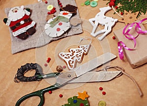 Lot of stuff for handmade gifts, scissors, ribbon, paper with countryside pattern, ready for holiday concept, nobody