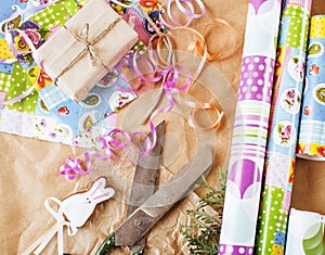 Lot of stuff for handmade gifts, scissors, ribbon, paper with countryside pattern, ready for holiday concept, nobody