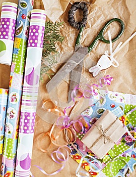 Lot of stuff for handmade gifts, scissors, ribbon, paper with countryside pattern, ready for holiday concept, nobody