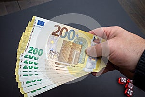 lot of two hundred euro banknotes are held in one hand