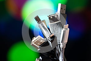 A lot of usb wires. A bunch of wires on a colored background