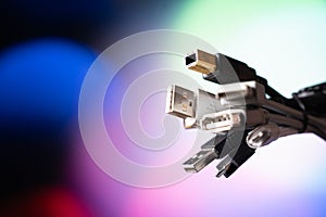 A lot of usb wires. A bunch of wires on a colored background