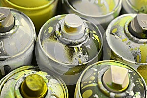 A lot of used spray cans of paint close-up. Dirty and smeared cans for drawing graffiti. The concept of a sweeping and careless d