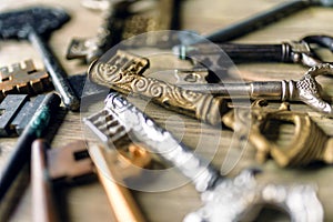A lot of vintage keys close-up on a wooden background