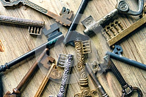 A lot of vintage keys on a wooden background