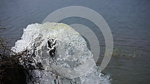 Lot of water gushing out of the big metal pipe to the lake