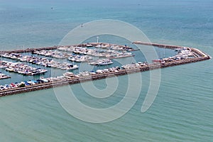 A lot of white boats and yachts moored in Yacht harbor. Yacht harbor in blue sunset light, luxury summer cruise, leisure time, act