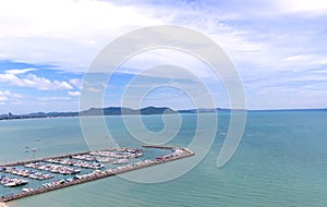 A lot of white boats and yachts moored in Yacht harbor. Yacht harbor in blue sunset light, luxury summer cruise, leisure time, act