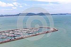 A lot of white boats and yachts moored in Yacht harbor. Yacht harbor in blue sunset light, luxury summer cruise, leisure time, act