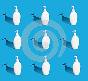 A lot of white bottles with dispenser on a blue background.