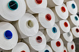 A lot of yarn on spools in a textile factory, production line. Beautiful background