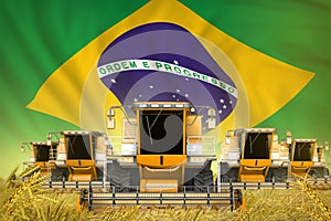 A lot of yellow farming combine harvesters on rye field with Brazil flag background - front view, stop starving concept -