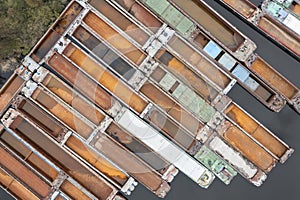 .Lots of abandoned transport barges moored side by side at the wharf. River transport industry