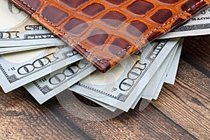 Lots of american hundred dollar bills in a leather wallet