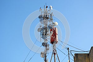 Advanced Wireless Network Infrastructure: Antennas, Telecommunication, and Satellite Dishes on Building Roof