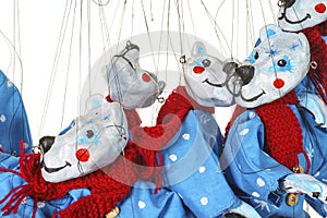 Lots of Bear puppets on strings in Christmas costumes close up