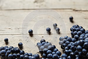 A lots of blue wine grapes on a old wooden table, copyspace