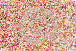 Lots of brightly colored sugar granules background used for topping desserts, cupcakes and ice cream in Top View It`s a colorful