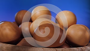 Lots of brown eggs on wooden plate spinning