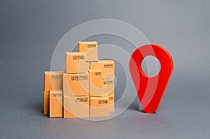 Lots of cardboard boxes and a red position pin. Locating packages and goods. Tracking parcels by the Internet. Algorithm