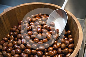 Lots of chestnuts at the market. Pile of nuts in a wood basket