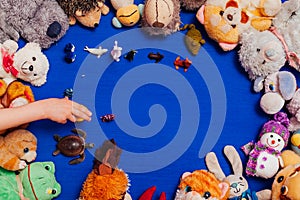 lots of children's soft animal toys on a blue background