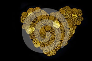 Lots coin gold Arranged in heart shape on black background texture, Investment and saving concept, Money stack for business