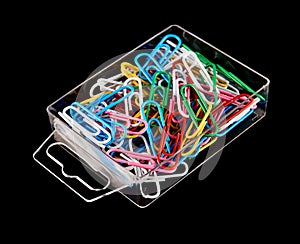 Lots of colored paper clips isolated on black background