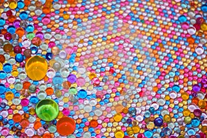 Lots of colorful glass balls of different sizes as background