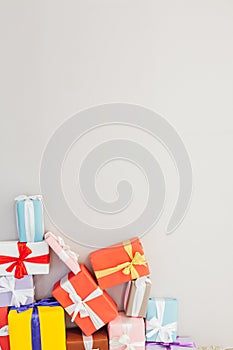 Lots of colorful holiday gifts on a grey background