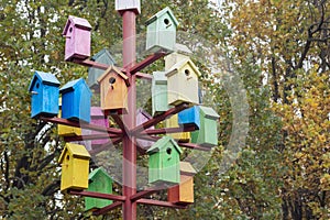 Lots of colorful nesting boxes. Many bright colored birdhouses