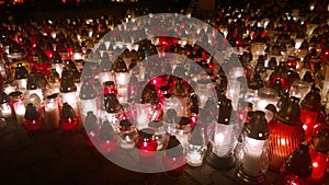 Lots of colourful grave candles shining at night