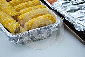 Lots of corn on the cob at a family gathering