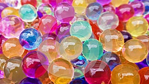 Lots of different colored hydrogel balls. Set of multicolored orbis. Crystal water beads for games. Helium balloons. Can be used