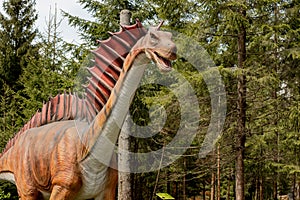 Lots of different dinosaurs in the park photo