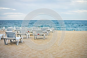 Lots of empty chairs on a deserted beach